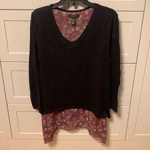 Black knit sweater with flower printed layer underneath.